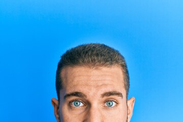 Young caucasian man showing head and half face relaxed with serious expression on face. simple and natural looking at the camera.