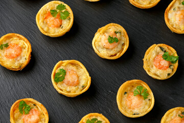 Mini party Fish Pie Food with prawn on rustic stone background
