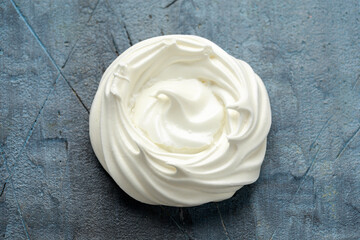 Sweet white meringue on old rustic table