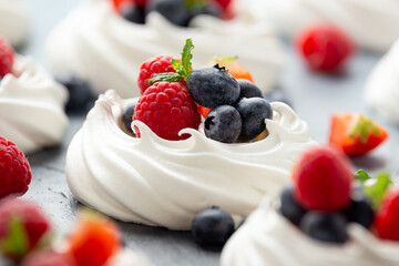 Meringue nest mini pavlova cake with fresh berries strawberry blueberry raspberry and mint for...