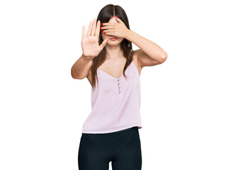 Obraz na płótnie Canvas Young beautiful caucasian girl wearing casual clothes covering eyes with hands and doing stop gesture with sad and fear expression. embarrassed and negative concept.