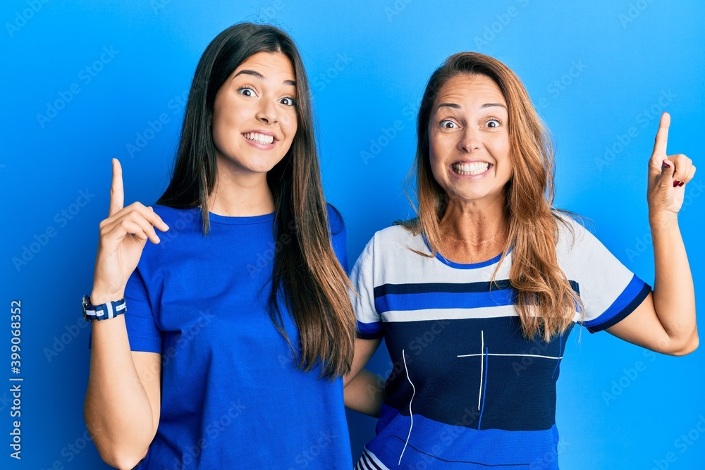 Sticker hispanic family of mother and daughter wearing casual clothes over blue background smiling amazed an