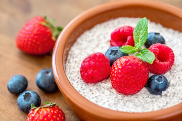 Chia seed pudding made with fruits and fresh  berries over wood background. Chia seeds Yogurt.