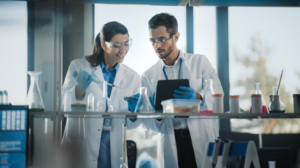 Medical Science Laboratory with Diverse Team of Research Scientists Working. Microbiologist Working...