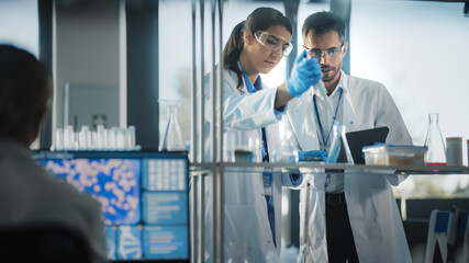 Medical Science Laboratory with Diverse Team of Research Scientists Working. Microbiologist Working...