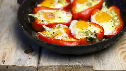 Selective focus. Macro. Baked red peppers with egg in a frying pan. Healthy food. The keto diet.