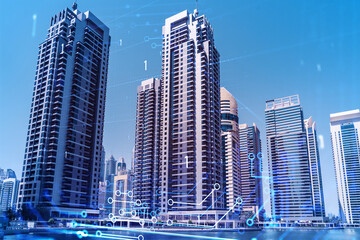 Obraz premium Skyscrapers of Dubai business downtown. International hub of trading and financial services. Technology theme icons hologram, Fintech concept. Double exposure. Dubai Canal waterfront.