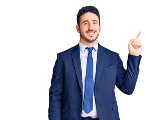 Young hispanic man wearing business clothes smiling happy pointing with hand and finger to the side