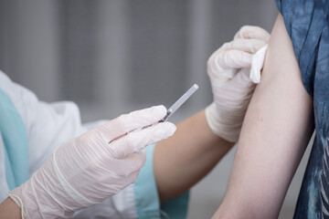 Close-up hands,nurses are vaccinations to patients using the syringe.Doctor vaccinating women in hospital.Are treated by the use of sterile injectable upper arm. injection,antibody,influenza vaccine