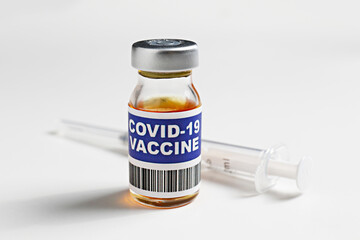 Macro shot of antiviral vaccine vial for immunization against covid-19 virus. Isolated on white background with copy space for text. Close up, top view.