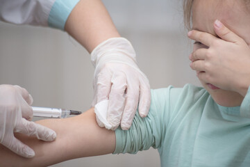 A doctor makes a vaccination to a child