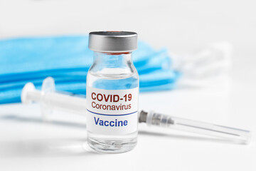 Macro shot of antiviral vaccine vial for immunization against covid-19 virus. Isolated on white background with copy space for text. Close up, top view.