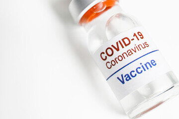 Macro shot of antiviral vaccine vial for immunization against covid-19 virus. Isolated on white background with copy space for text. Close up, top view.