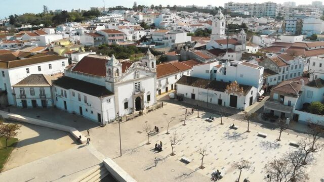 Church of Santa Maria de Lagos in the Old town Square, in Algarve, Portugal - Aerial Panoramic Ascending shot