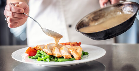 Slices of chicken breasts served on green beans and tomatoes with a mushroom sauce poured over it