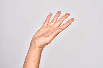 Obraz na płótnie Canvas Hand of caucasian young man showing fingers over isolated white background presenting with open palm, reaching for support and help, assistance gesture