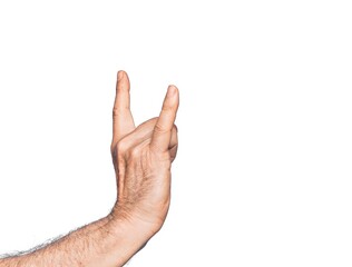 Naklejka premium Hand of caucasian middle age man over isolated white background gesturing rock and roll symbol, showing obscene horns gesture