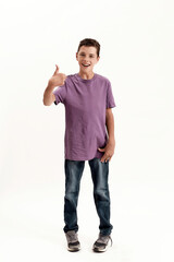 Full length shot of teenaged disabled boy with cerebral palsy smiling and showing thumbs up at...