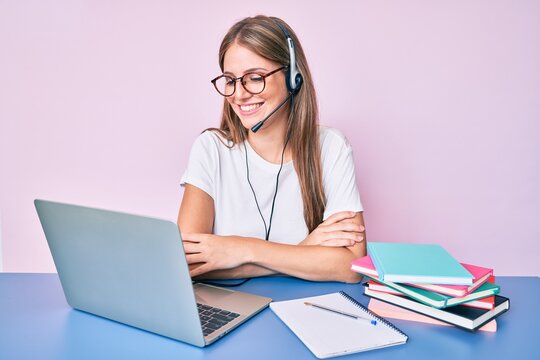 Young Blonde Girl Wearing Operator Headset At The Call Center Office Happy Face Smiling With Crossed Arms Looking At The Camera. Positive Person.