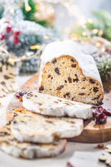 Christmas Stollen. Traditional Sweet Fruit Loaf with Icing Sugar. Xmas holiday table setting.