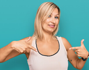 Middle age caucasian woman wearing casual clothes looking confident with smile on face, pointing oneself with fingers proud and happy.