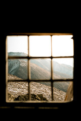 Mountain range from the window of an abandoned house