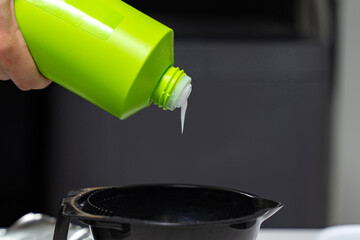 Hairdresser calorist mixes ingredients for hair coloring. hair dyeing process
