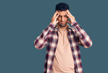 Young hispanic man wearing casual clothes suffering from headache desperate and stressed because pain and migraine. hands on head.