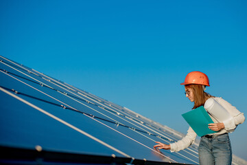 Businesswomen working on checking equipment at solar power plant with tablet checklist, woman...