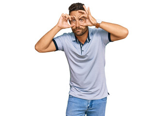 Handsome man with beard wearing casual clothes trying to open eyes with fingers, sleepy and tired for morning fatigue