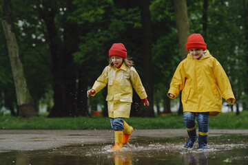 Kids in a puddle. Child having fun outdoors.