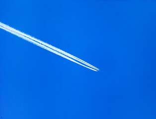 The trace of a flying plane in the blue sky