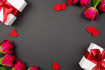 Gift boxes with beautiful red ribbon, hearts and roses on dark background. Flat lay concept of Valentine's, anniversary, mother's day and birthday greeting. Top view. Copy space. Mockup.