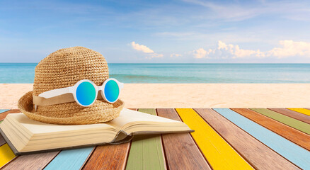 Open book on multicolor wood panel and sea beach background.Summer holiday concept. - Powered by Adobe