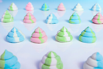 Pastel reindeer poop marshmallows on a reflective background