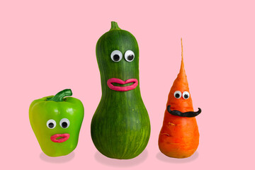 funny vegetables with eyes and mouths made of plasticine on a pink background,GMO foods and hand made games with kids concept