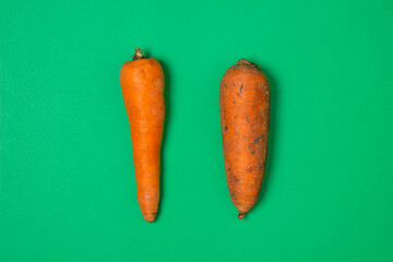 Carrots on a green background. Healthy eating. Washed carrots next to dirty carrots