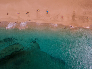 Aerial view of the jagged shores and beaches of La Graciosa island. Bathers on the beach of las Conchas. The main archipelago island Chinijo, a mile northwest of Lanzarote. Canary island. Spain. Ocean