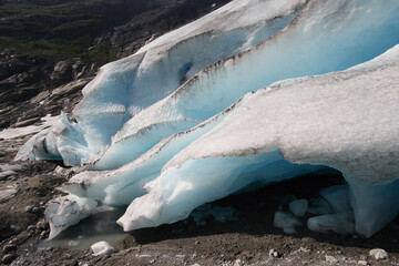 A large pieces of ice from a glacier melting in the Norwegian mountain during a sunny summer day. 