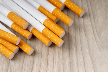 cigarettes. pile on wooden background. image of several commercially made or Non smoking campaign concept, tobacco.