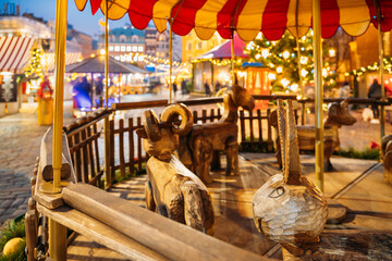 Fototapeta na wymiar Riga, Latvia. Traditional Vintage Old Carousel Merry-go-round On Christmas Market On The Dome Square. Winter Holidays, New Year In Europe