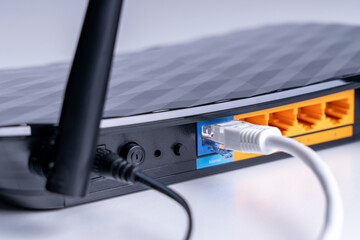 Wi-Fi router close-up, wireless Internet device close-up, selective focus, tinted image, wires...
