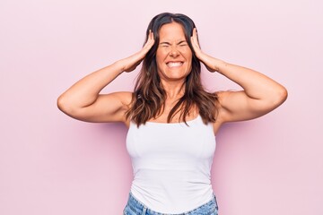 Young beautiful brunette woman wearing casual sleeveless t-shirt over white background with hand on...