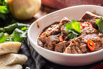 Bowl of Viennese goulash with chillies and dumplings