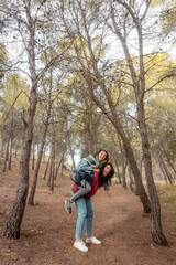 Fototapeta premium Lesbian couple sticking out her tongue as a sign of protest and attitude in nature. Autumn and vintage landscape