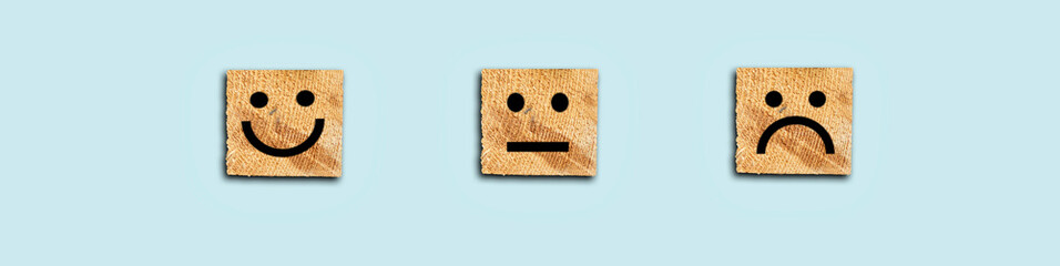 Customer service evaluation and satisfaction survey concepts. Face icon on wooden cube