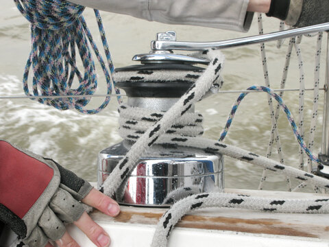 Turning rope on a winch of sailboat