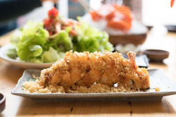 A set of sushi on a wooden table in a Japanese restaurant.Fresh salmon sliced for sushi menu.