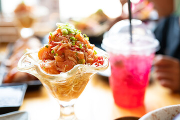 A set of sushi on a wooden table in a Japanese restaurant.Fresh salmon sliced for sushi menu.