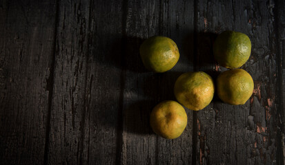 Sweet lime fruits on dark wooden table